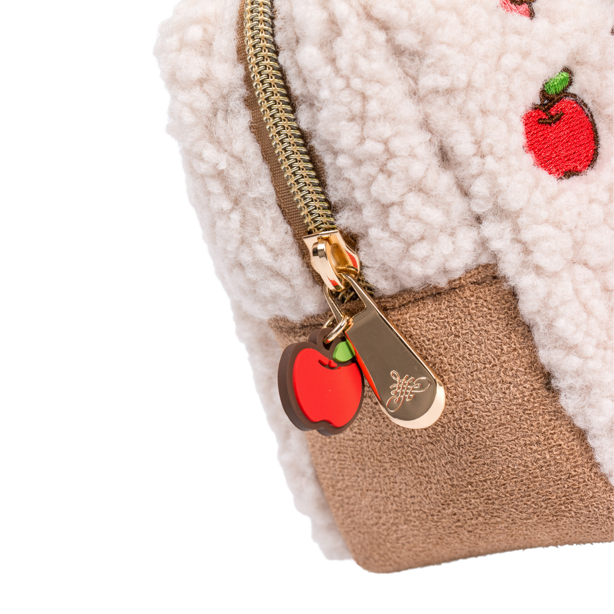 Up close of zipper and apple charm