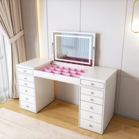 White vanity desk with mirror and pink organizers in a room with curtains and a rug.